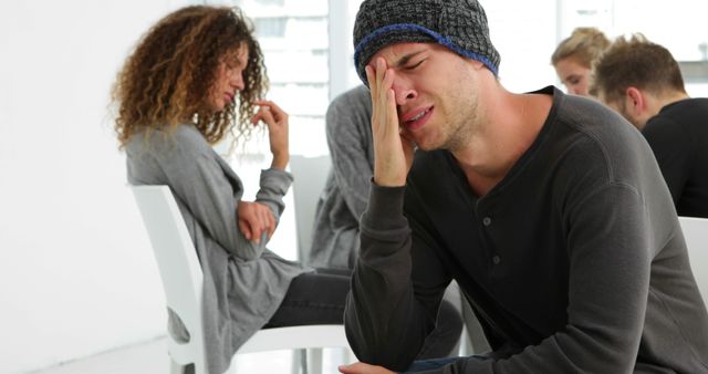 Desperate man crying in group therapy - Download Free Stock Photos Pikwizard.com