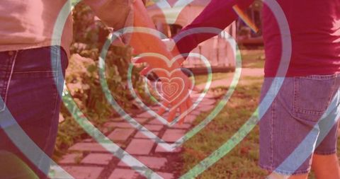 Romantic Couple Holding Hands Along Scenic Garden Path