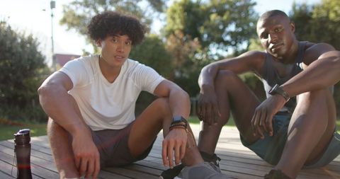 Diverse Friends Relaxing After Workout in Backyard