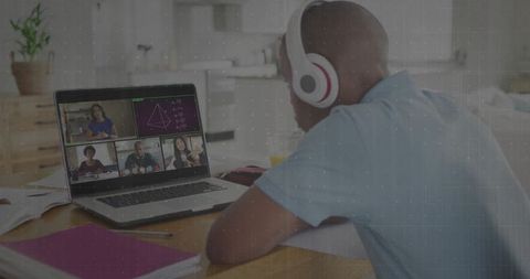 Teen student engaging in online class from kitchen