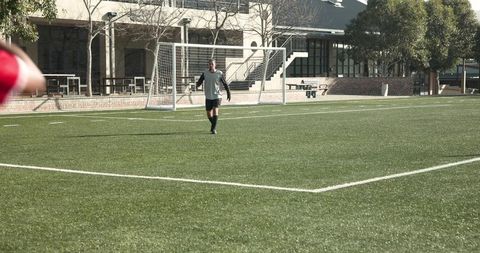 Intense Soccer Match with Players in Action on Green Field