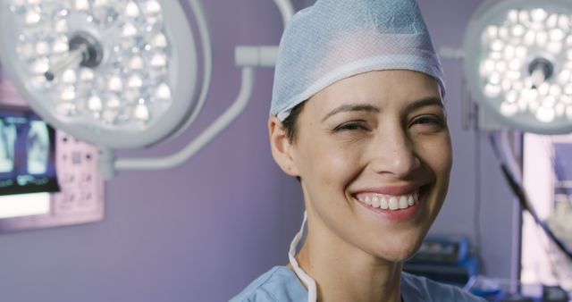 Female Doctor Smiling in Operating Room Under Surgical Lights - Download Free Stock Images Pikwizard.com