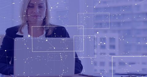 Businesswoman Analyzing Data Using Laptop in Modern Office