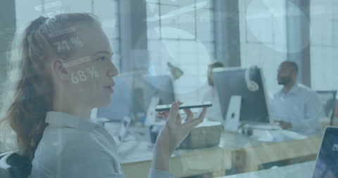 Businesswoman Uses Smartphone in Data Driven Office Environment