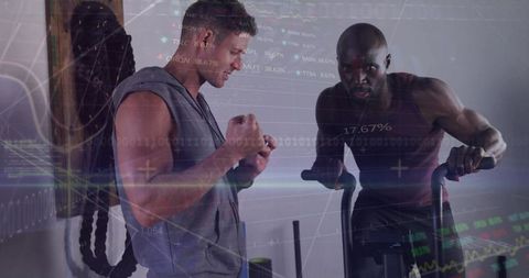 Fitness trainer motivating client on elliptical in modern gym