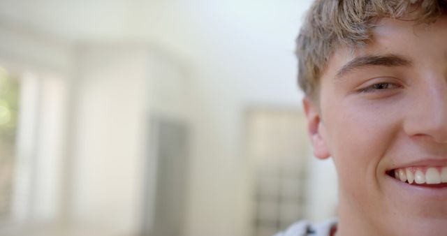 Close-Up of Smiling Young Man Indoors Half Face - Download Free Stock Images Pikwizard.com