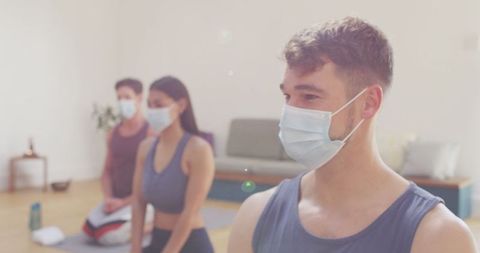Diverse Group in Yoga Class Wearing Face Masks During Pandemic