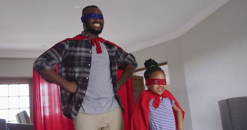 Father and Daughter Enjoying Home Time in Superhero Costumes