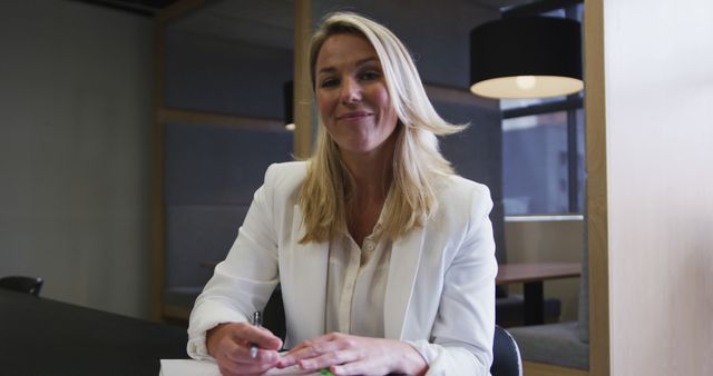 Confident Businesswoman Smiling While Working in Modern Office - Download Free Stock Images Pikwizard.com