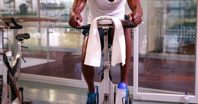 Athletic Man Training on Stationary Bike in Gym - Download Free Stock Images Pikwizard.com