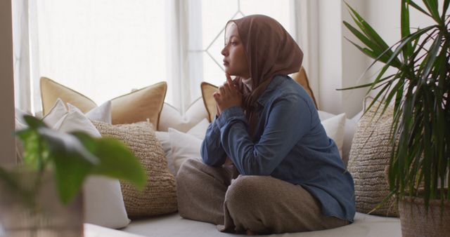 Pensive Muslim Woman Sitting on Couch in Bright Room - Download Free Stock Images Pikwizard.com