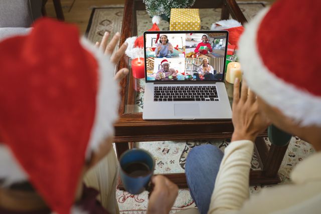 Diverse Couple Video Calling Friends on Christmas Day Wearing Santa Hats - Download Free Stock Images Pikwizard.com