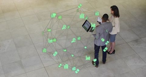 Business Professionals Examining Holographic Financial Network Overlay in Corporate Lobby