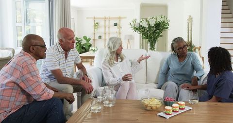 Senior Friends Enjoying Relaxing Conversation at Home