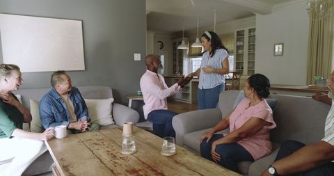 Diverse Senior Friends Enjoying Lively Conversation at Home