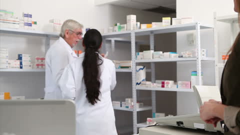 Pharmacists Discussing Amidst Medication at Clinic