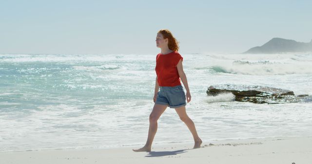 Young Woman Strolling Along Sunny Beach in Casual Attire - Download Free Stock Images Pikwizard.com