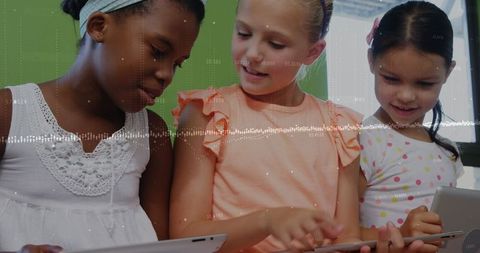Diverse Girls Collaborating with Tablets in Classroom Technology Education