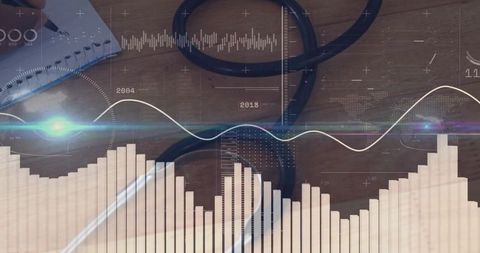 Writing in notebook analyzing data and business trends