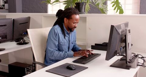 Focused Professional Typing on Office Desk