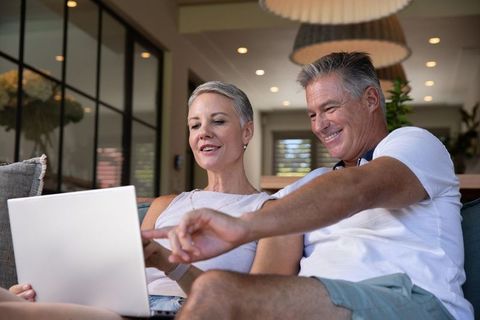 Senior Couple Using Laptop in Modern Living Room
