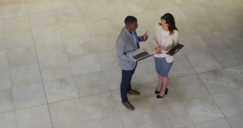 Business Professionals Discussing Project in Office Lobby