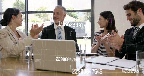 Executive receiving recognition while team applauding with digital data overlay