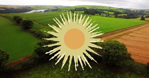 Stylized sunburst overlaying aerial farmland with green pastures and golden fields
