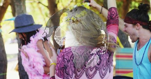 Friends celebrating park festival wearing colorful outfits, raising cups with globe overlay