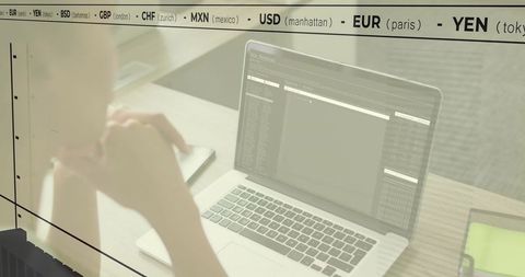 Woman Analyzing Financial Data on Laptop at Workspace