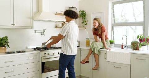 Couple Relaxing with Breakfast in Modern Bright Kitchen