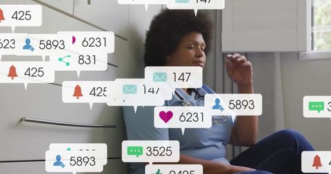 Afro-american female doctor overwhelmed by social media icons display