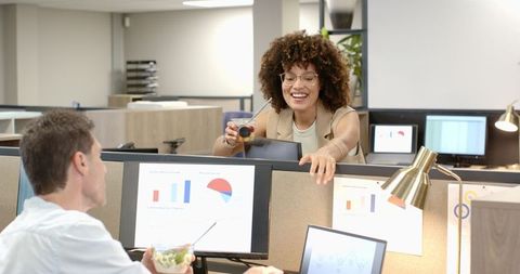 Office coworkers sharing healthy snacks in modern workplace