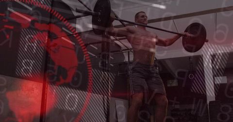 Shirtless athlete pressing loaded barbell overhead in gym with crimson graphic overlay
