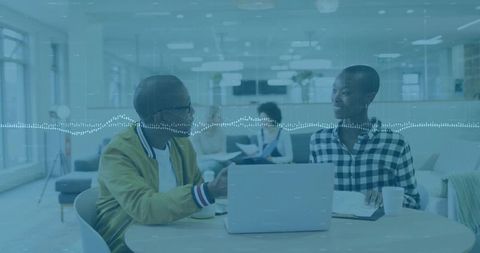 Colleagues Discussing Project in Modern Open-Plan Office Area