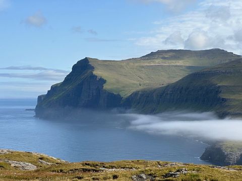 Majestic cliffs overlooking tranquil beach with mist