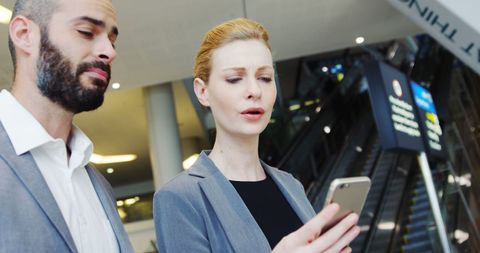 Business Professionals Discussing Work at Airport Terminal