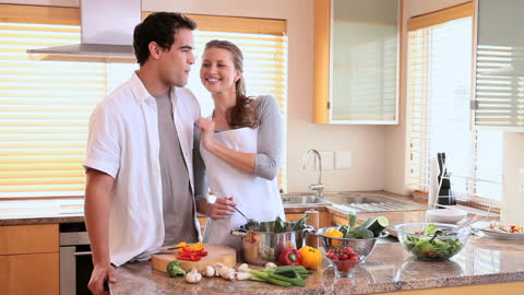 Couple Enjoys Cooking in Modern Kitchen