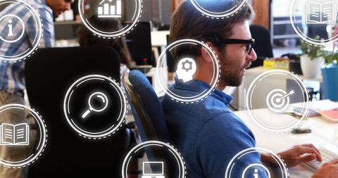 Businessman Analyzing Data with Futuristic Digital Icons Overlay