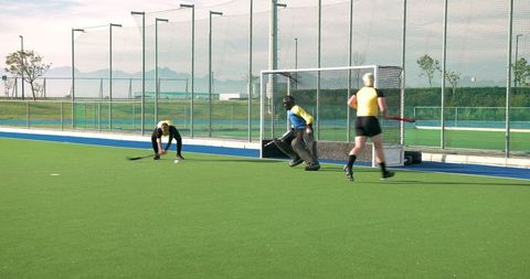 Teamwork on Outdoor Field Hockey Turf Pitch
