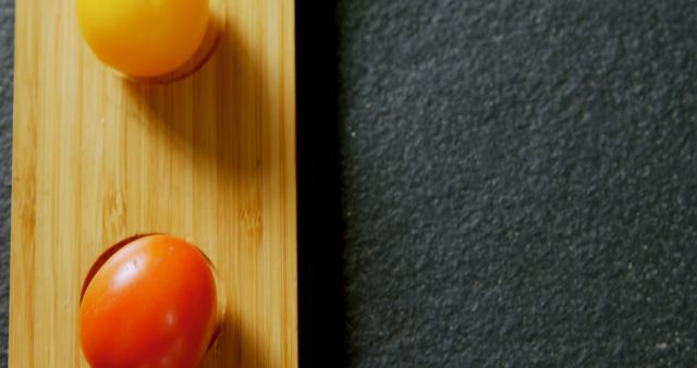 The tomatoes' colors pop against the contrasting wooden and dark countertop backgrounds. - Download Free Stock Photos Pikwizard.com