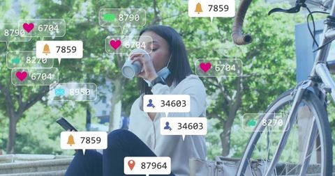 Asian Woman Enjoys Coffee in Park While Browsing Phone