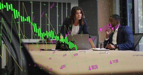 Colleagues Analyzing Financial Graphs in Modern Boardroom