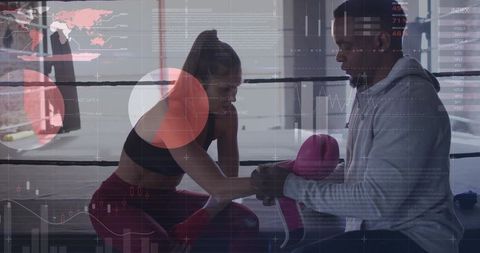Trainer Assists Female Boxer with Hand Wraps in Boxing Ring