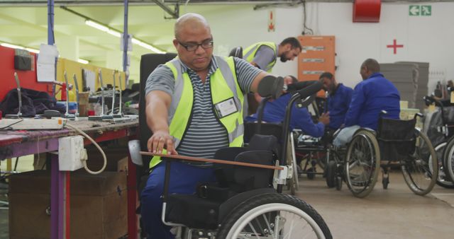 Disabled Worker Making Wheelchairs in Workshop - Download Free Stock Images Pikwizard.com