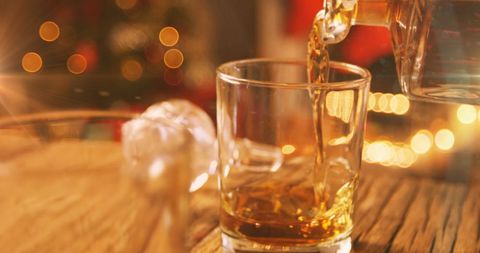 Pouring Whiskey in Glass with Christmas Cheer - Download Free Stock Images Pikwizard.com