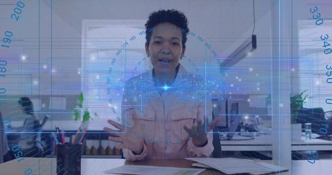 Presenting holographic AR interface while gesturing to camera in modern open-plan office