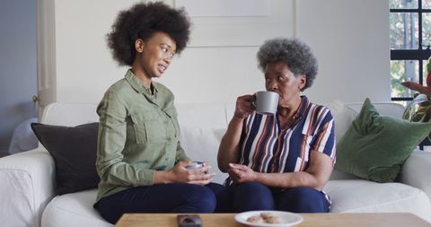Mother and Daughter Sharing Coffee and Conversation at Home