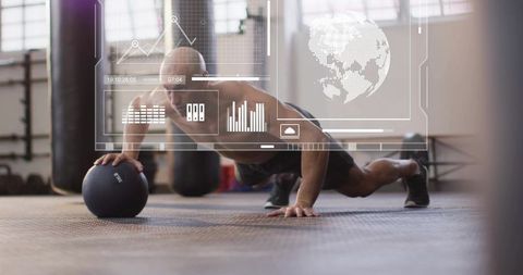 Shirtless athlete doing one-arm push-up on medicine ball with augmented fitness hud