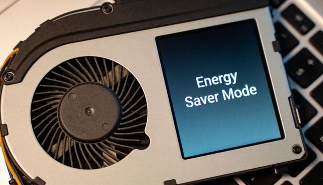 Laptop cooling assembly displaying energy saver mode on internal module close-up